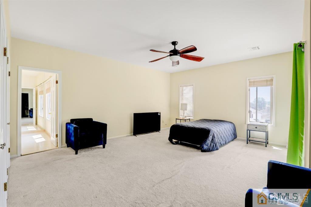 2 The Summit Holmdel, NJ 07733 - Photo 38 of 57 a bedroom with a bed and a couch