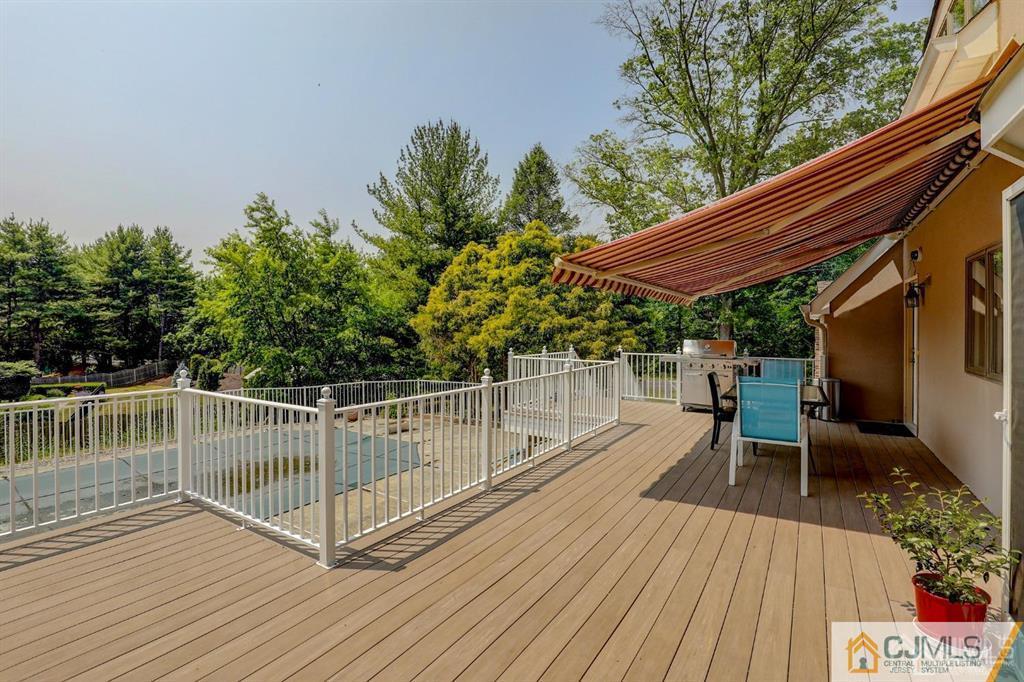 2 The Summit Holmdel, NJ 07733 - Photo 50 of 57 a view of a roof deck with chair and wooden floor