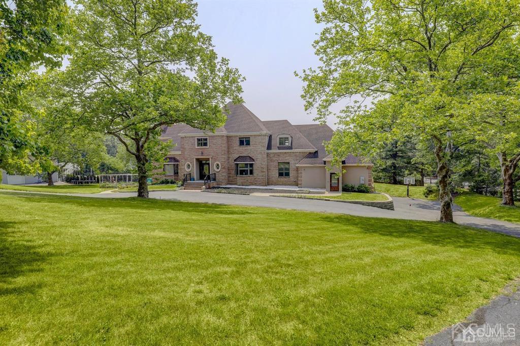 2 The Summit Holmdel, NJ 07733 - Photo 5 of 57 a house view with swimming pool in front of it