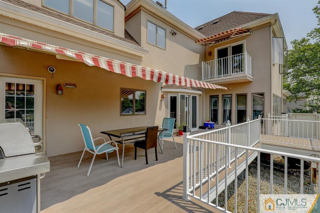 2 The Summit Holmdel, NJ 07733 - Photo 52 of 57 a view of a house with a patio and a dining table
