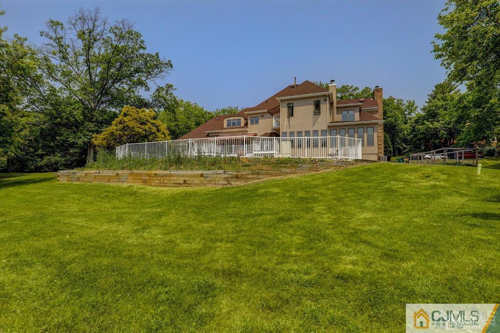 2 The Summit Holmdel, NJ 07733 - Photo 57 of 57 a view of a big house with a big yard and large trees