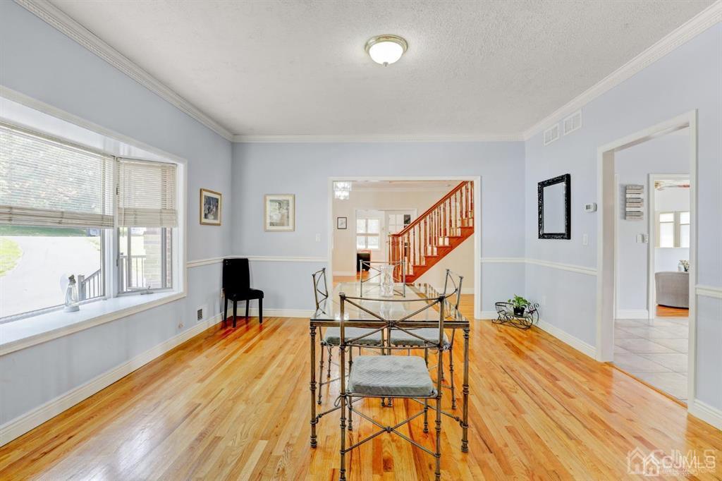 2 The Summit Holmdel, NJ 07733 - Photo 9 of 57 a view of a dining room with furniture a potted plant and wooden floor
