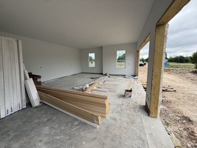 127 Riparian Elms Road Bertram, TX 78605 - Photo 20 of 22 A spacious, newly constructed garage offers ample storage with views of the surrounding natural landscape.