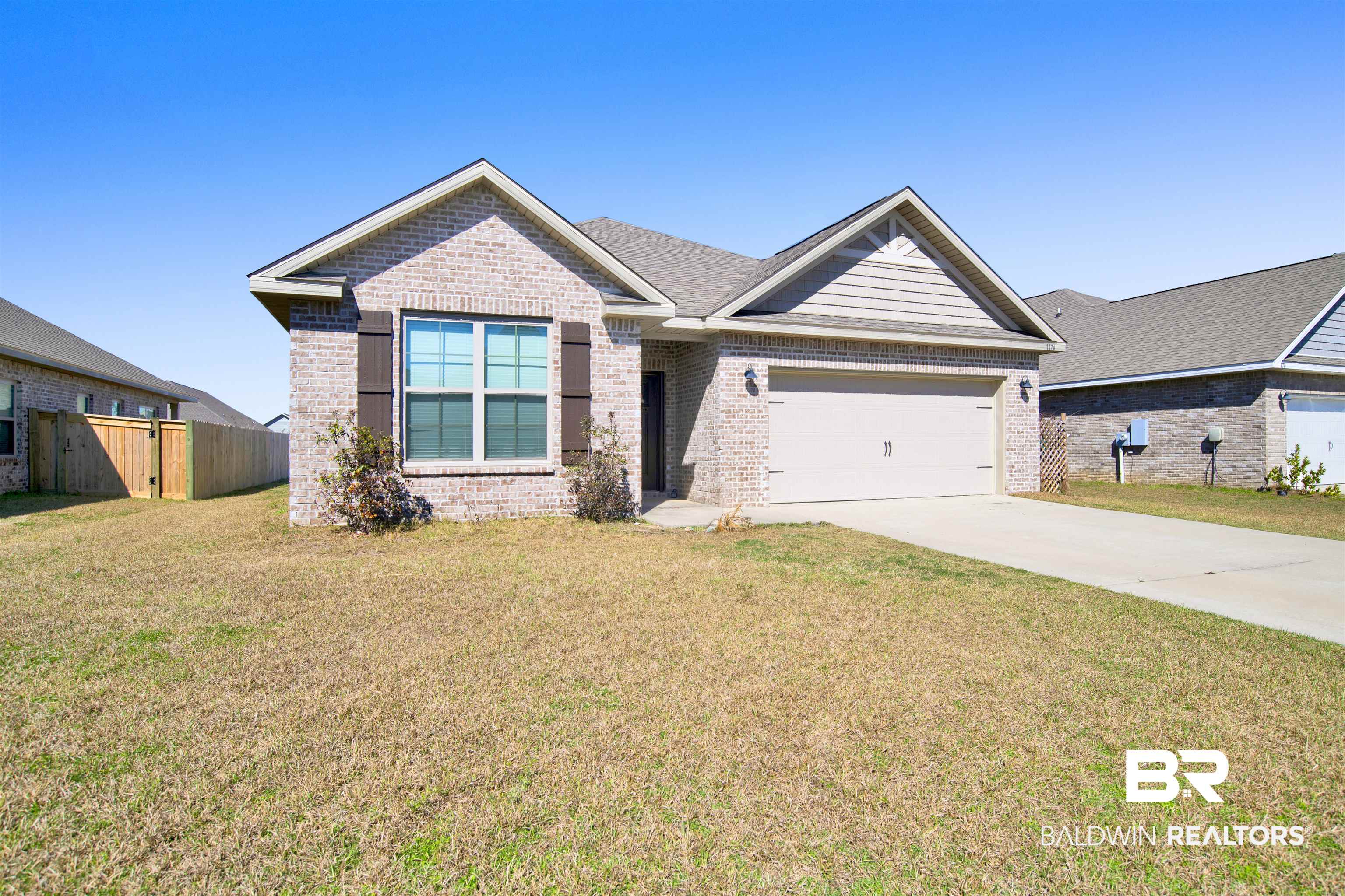 1174 Pheasant Circle Foley, AL 36535 - Photo 3 of 29 View of front of property featuring brick siding, concrete driveway, and a garage