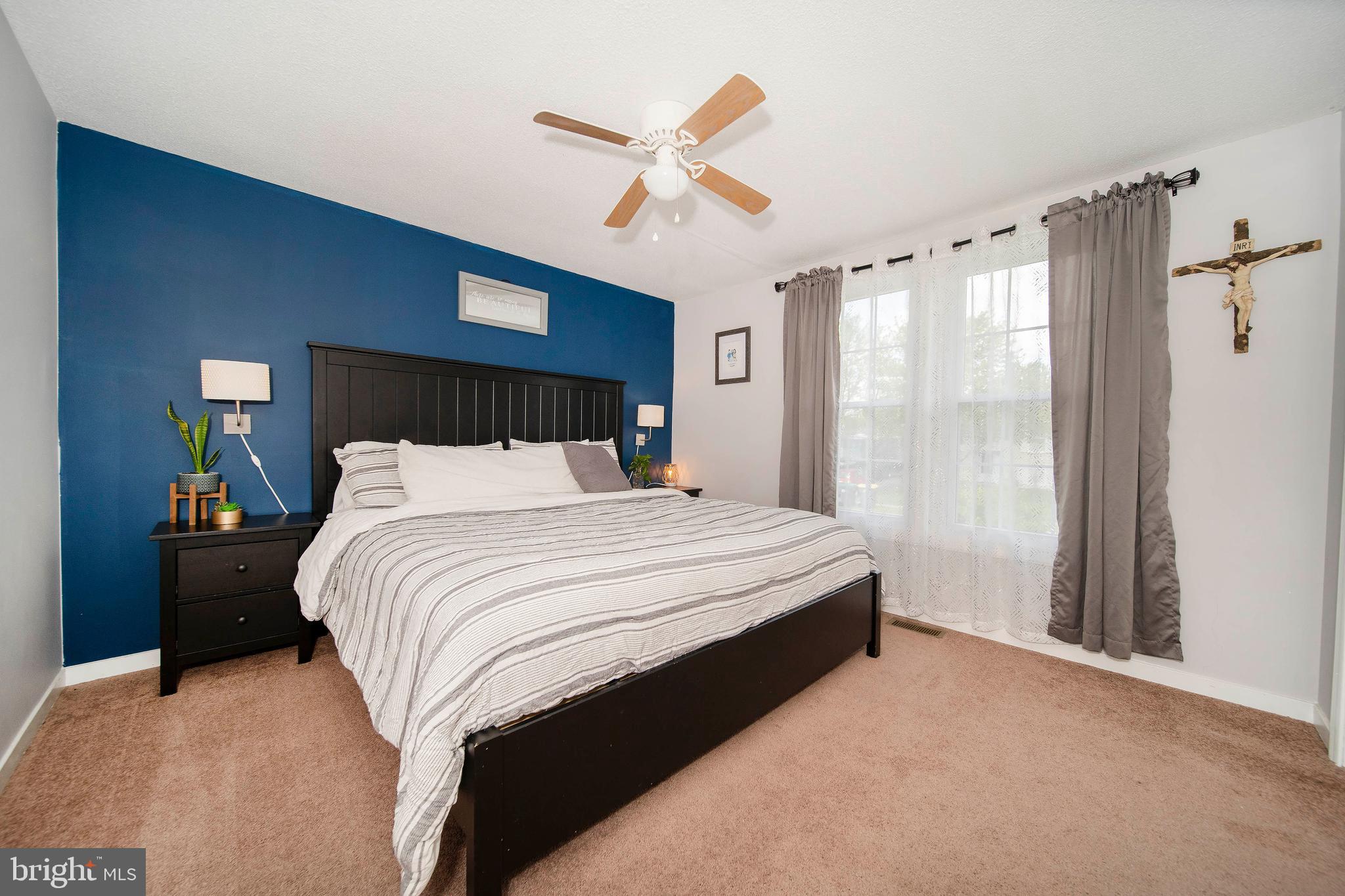 16 Leader Drive Newark, DE 19713 - Photo 12 of 28 a bedroom with a large bed and a large window