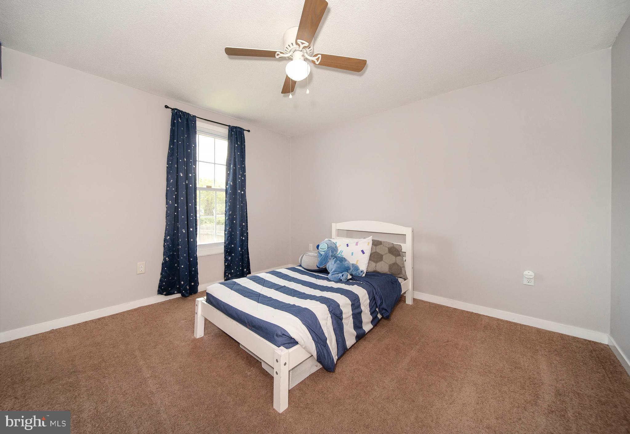 16 Leader Drive Newark, DE 19713 - Photo 15 of 28 a bedroom with a bed and a chandelier