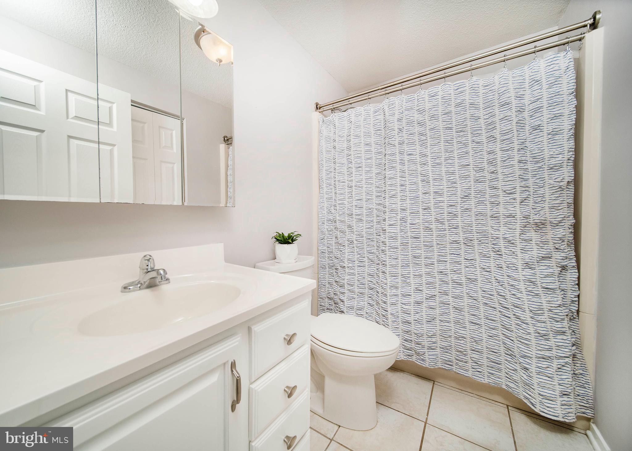 16 Leader Drive Newark, DE 19713 - Photo 17 of 28 a bathroom with a sink a toilet and shower