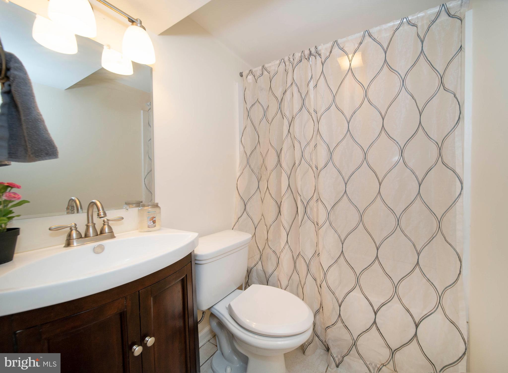 16 Leader Drive Newark, DE 19713 - Photo 18 of 28 a bathroom with a toilet sink and mirror