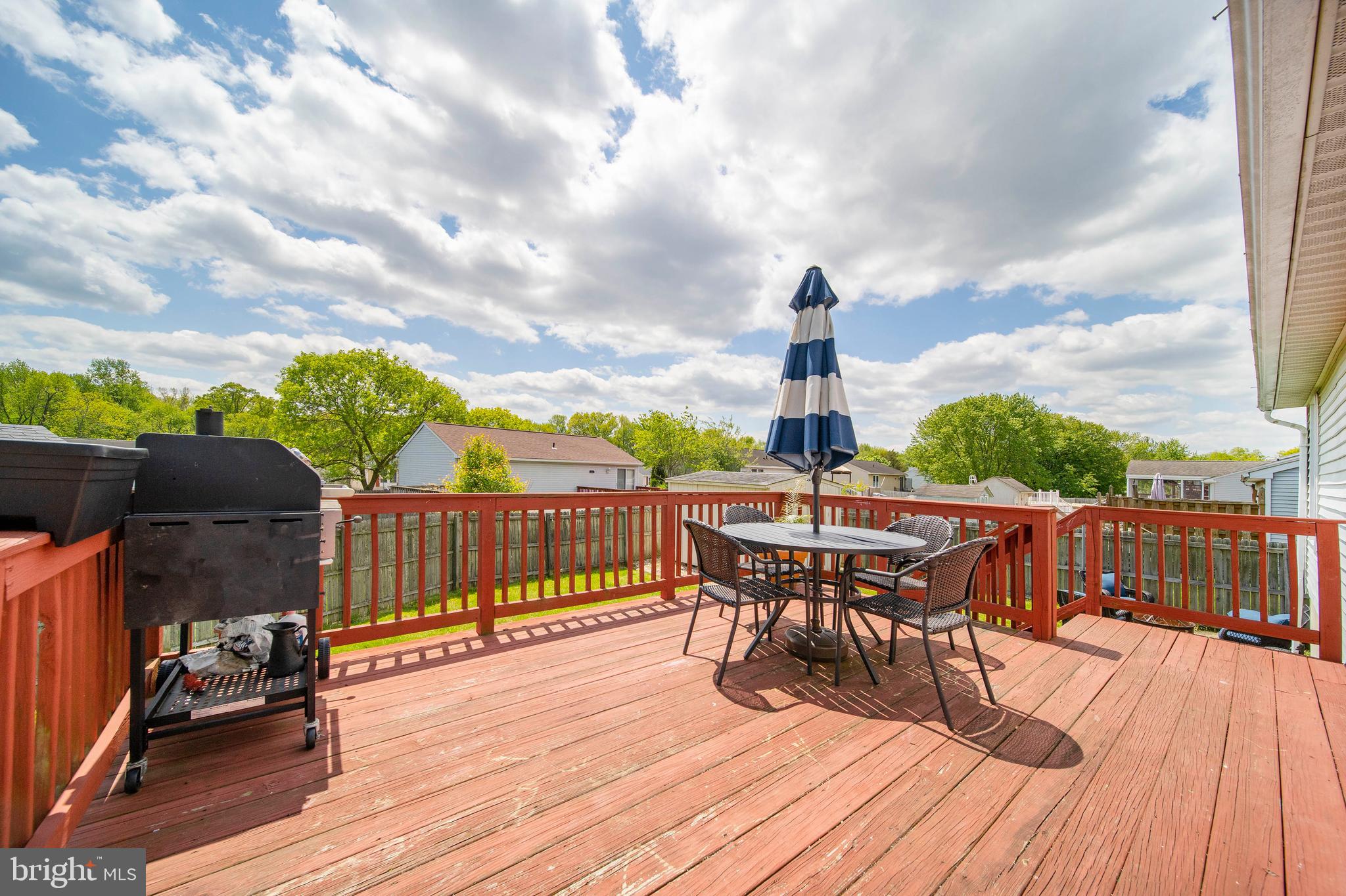 16 Leader Drive Newark, DE 19713 - Photo 25 of 28 a view of a roof deck with table and chairs a barbeque with wooden floor and fence
