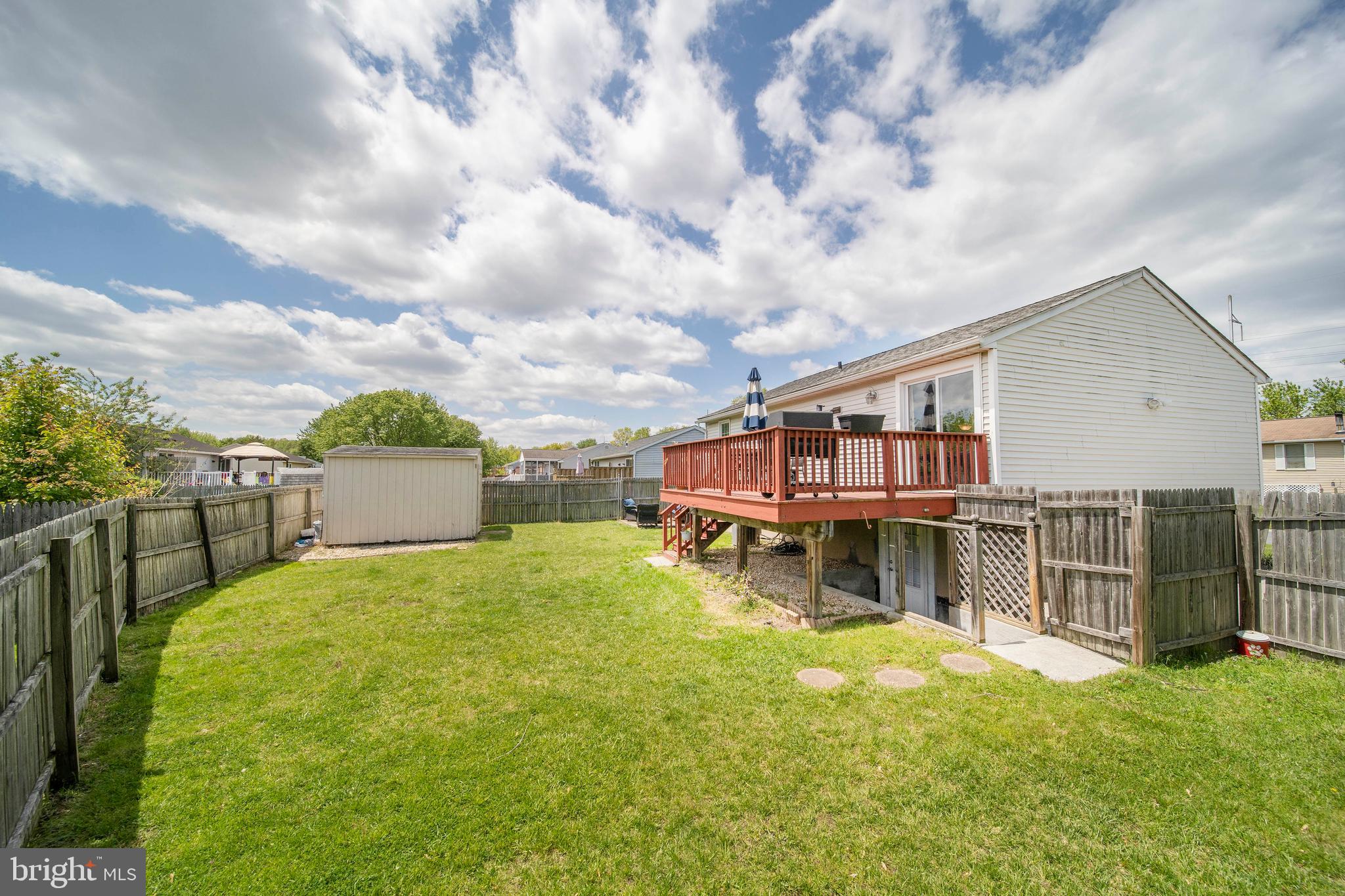 16 Leader Drive Newark, DE 19713 - Photo 27 of 28 a view of a house with a wooden deck and a big yard