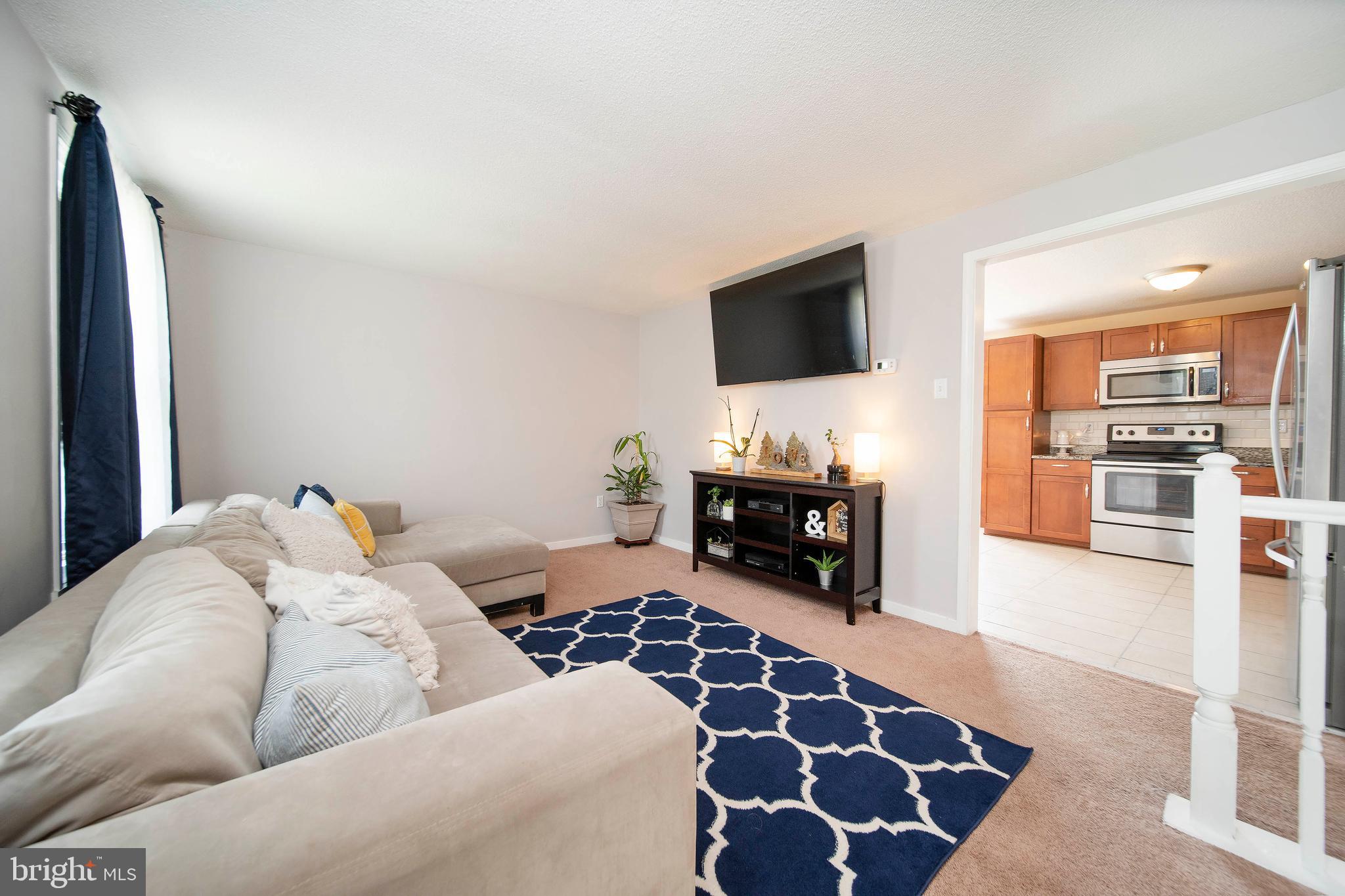 16 Leader Drive Newark, DE 19713 - Photo 5 of 28 a living room with furniture and a flat screen tv