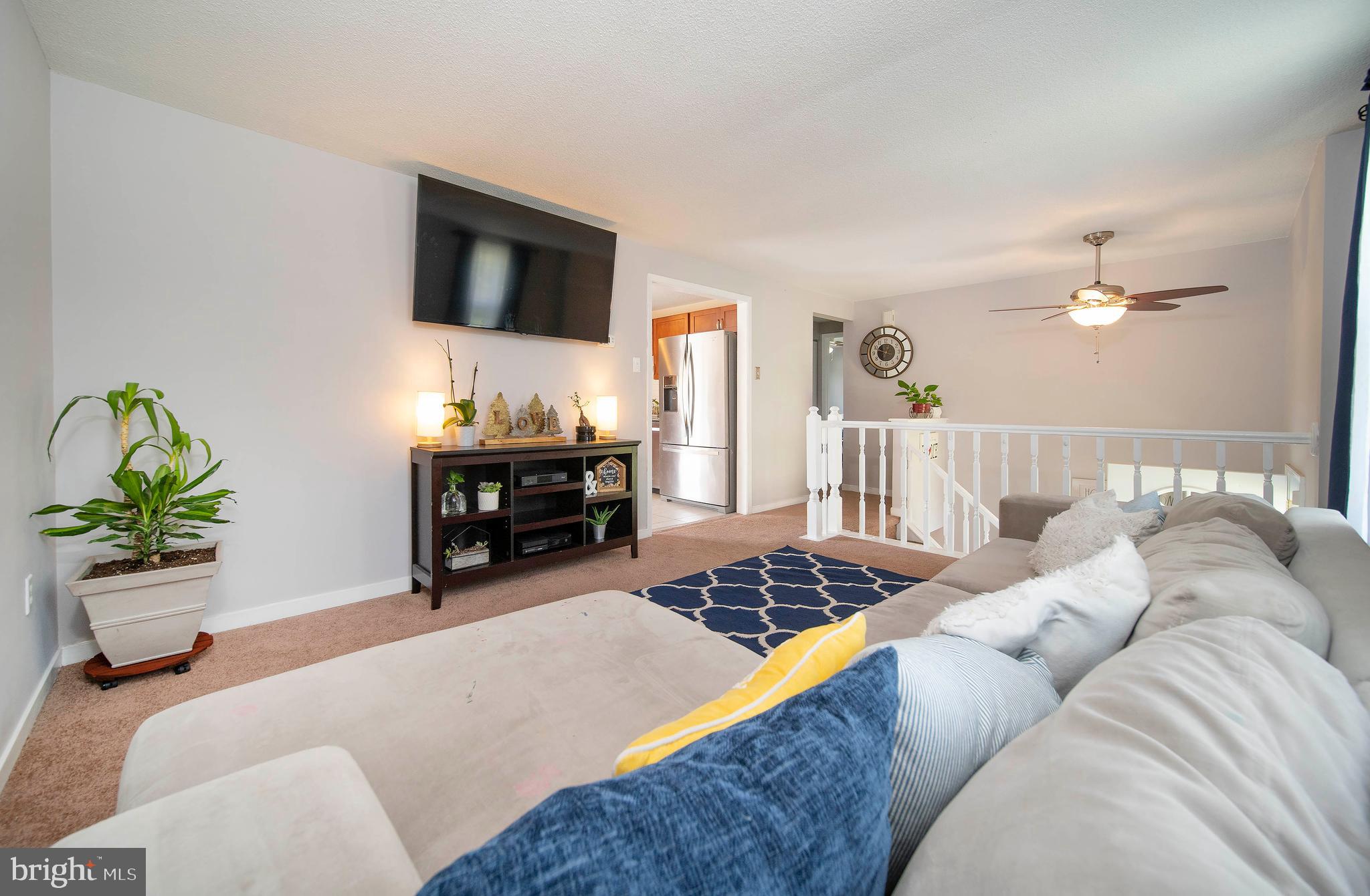 16 Leader Drive Newark, DE 19713 - Photo 6 of 28 a bedroom with a bed and a chandelier