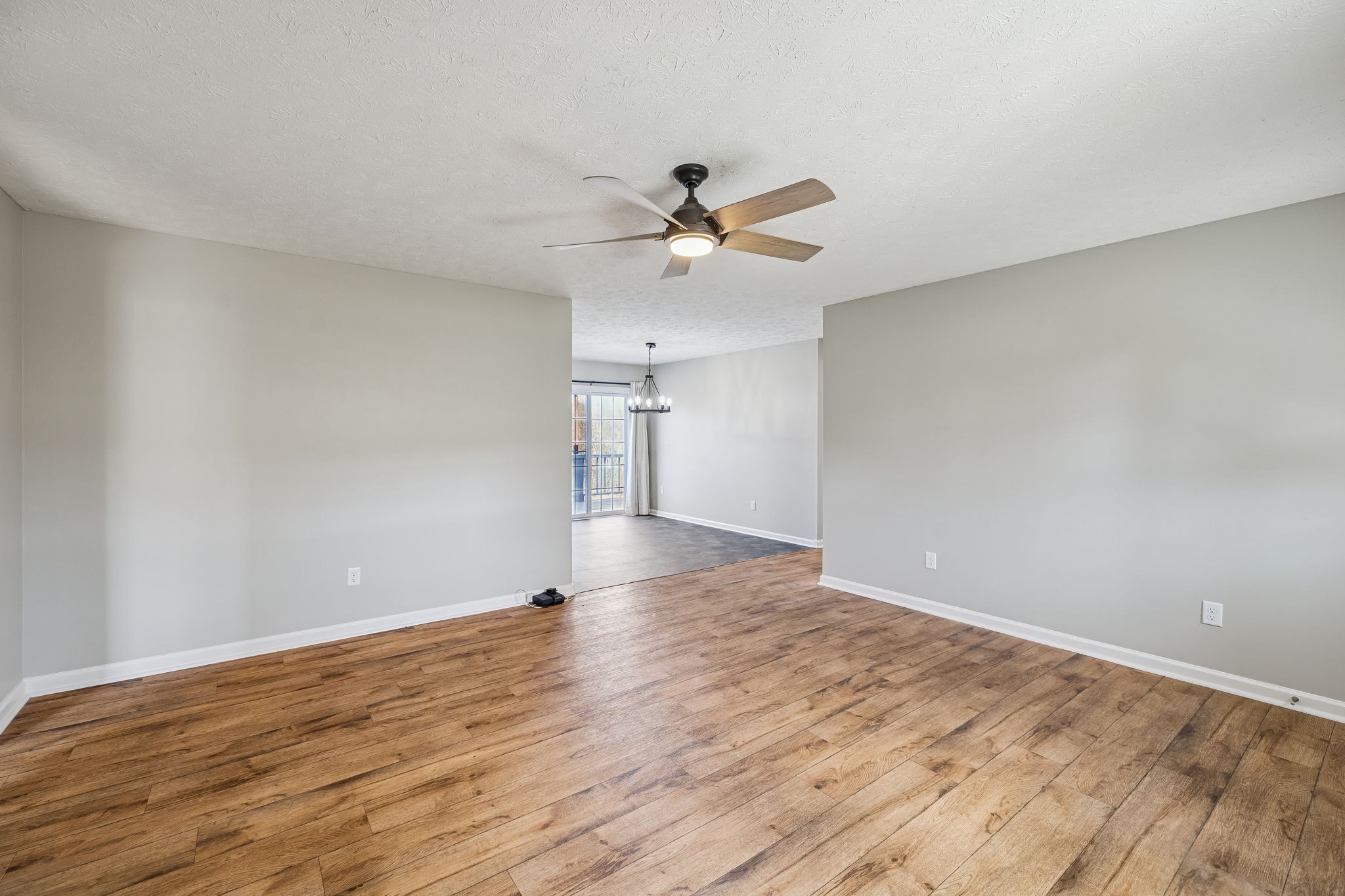 162 Pigeon Roost Road Brush Creek, TN 38547 - Photo 12 of 50 a view of a big room with wooden floor and a ceiling fan