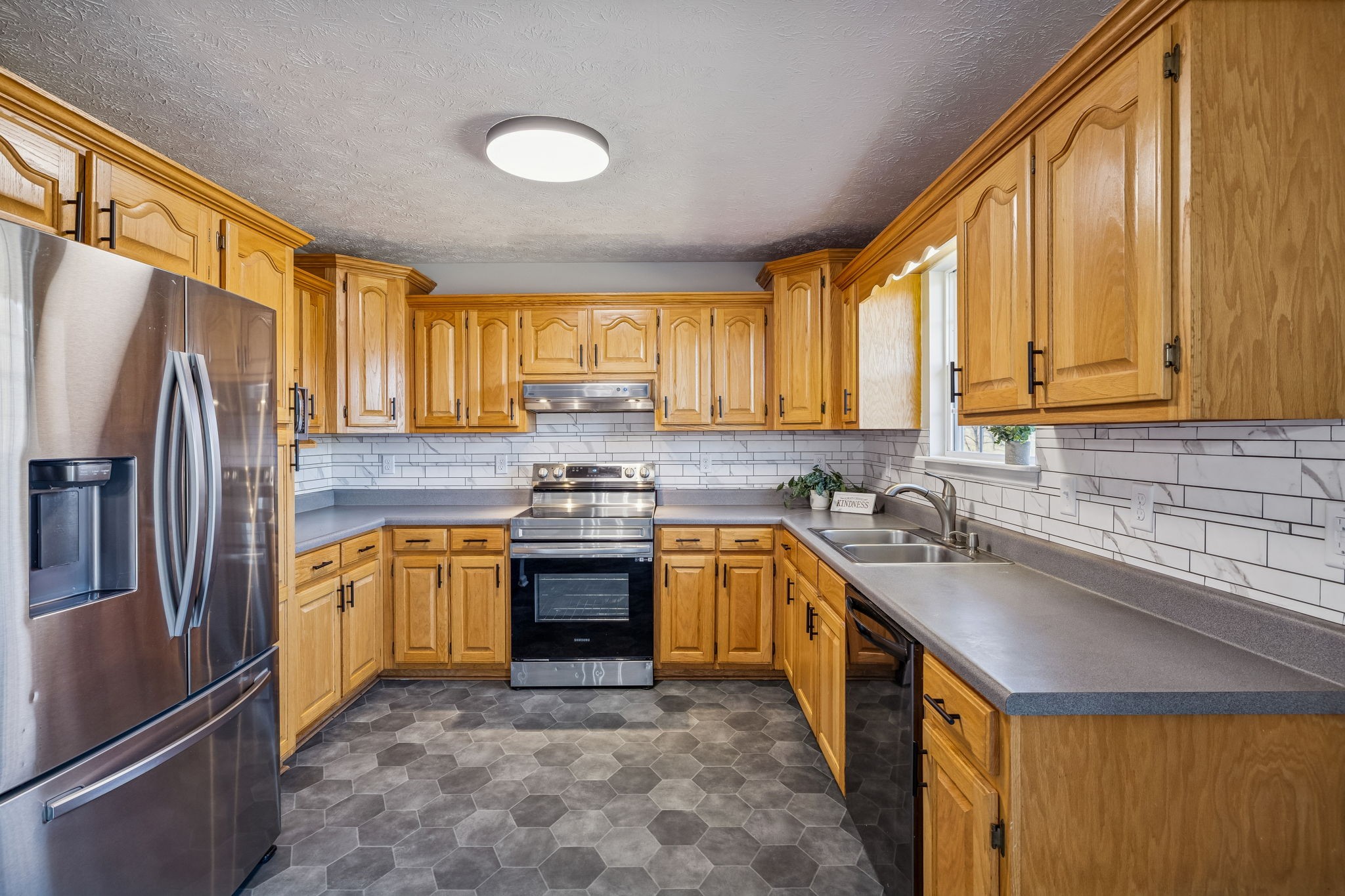162 Pigeon Roost Road Brush Creek, TN 38547 - Photo 16 of 50 a kitchen with stainless steel appliances granite countertop a sink stove refrigerator and cabinets