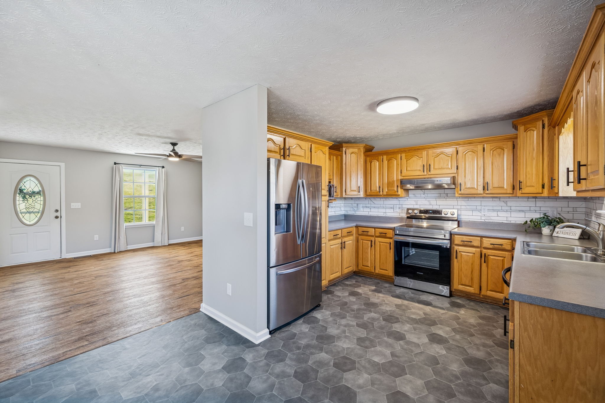 162 Pigeon Roost Road Brush Creek, TN 38547 - Photo 17 of 50 a kitchen with granite countertop a refrigerator stove top oven and sink
