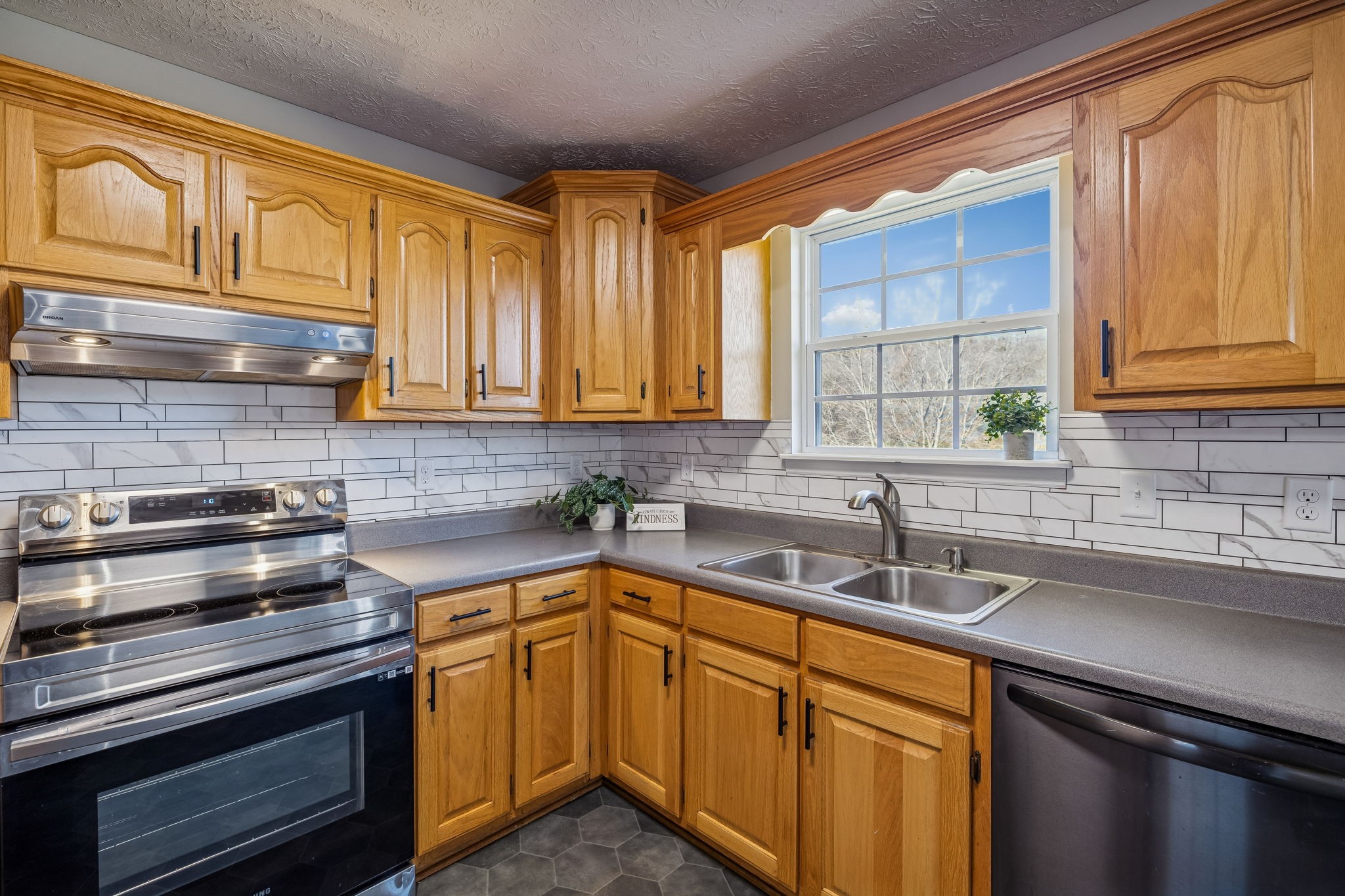 162 Pigeon Roost Road Brush Creek, TN 38547 - Photo 19 of 50 a kitchen with stainless steel appliances granite countertop a sink stove and cabinets