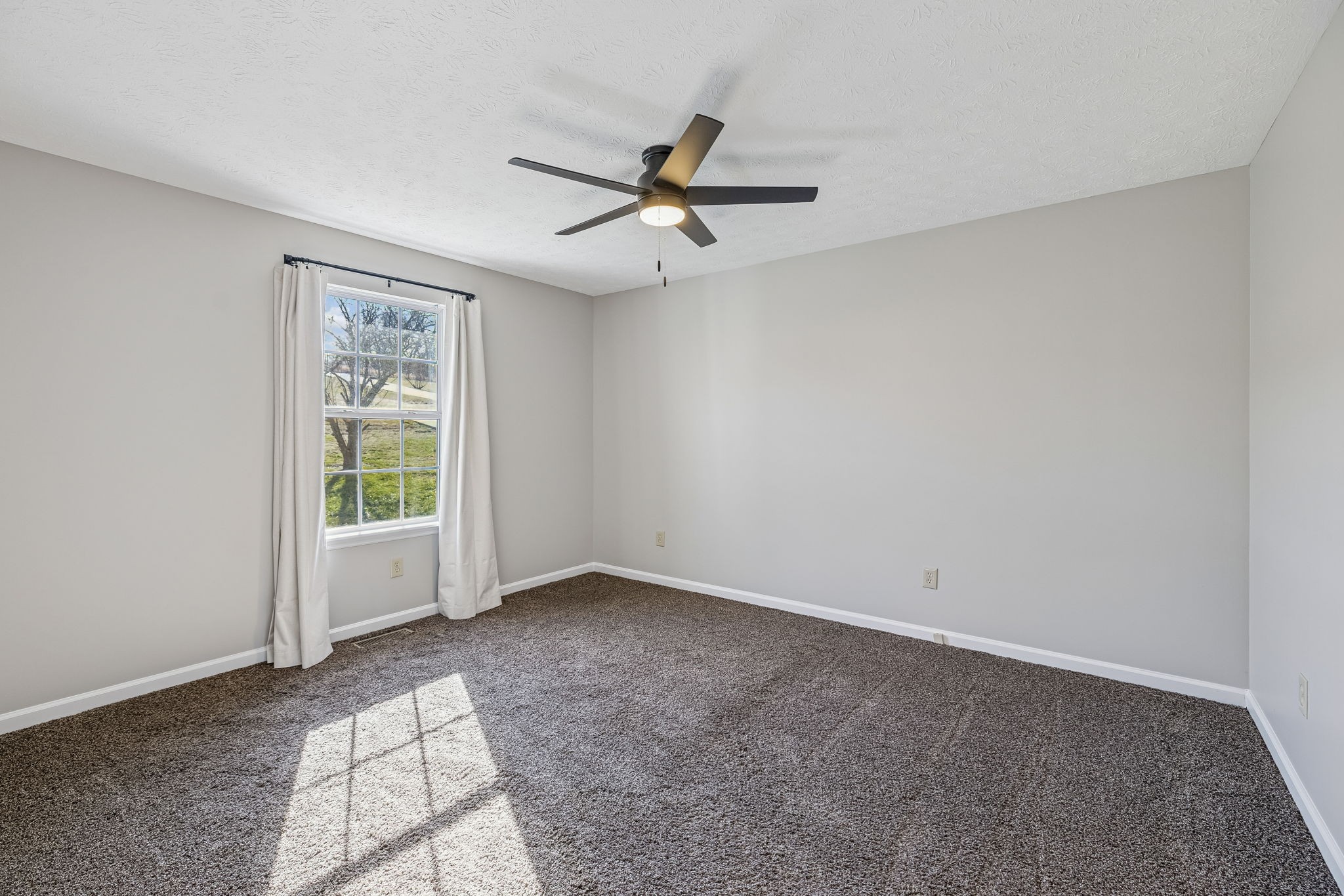 162 Pigeon Roost Road Brush Creek, TN 38547 - Photo 21 of 50 an empty room with windows and fan