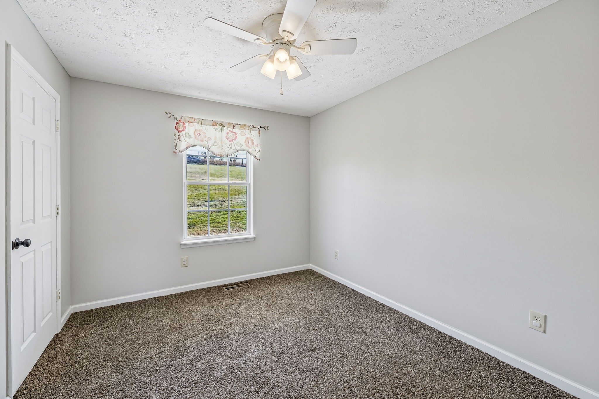162 Pigeon Roost Road Brush Creek, TN 38547 - Photo 31 of 50 an empty room with windows and fan
