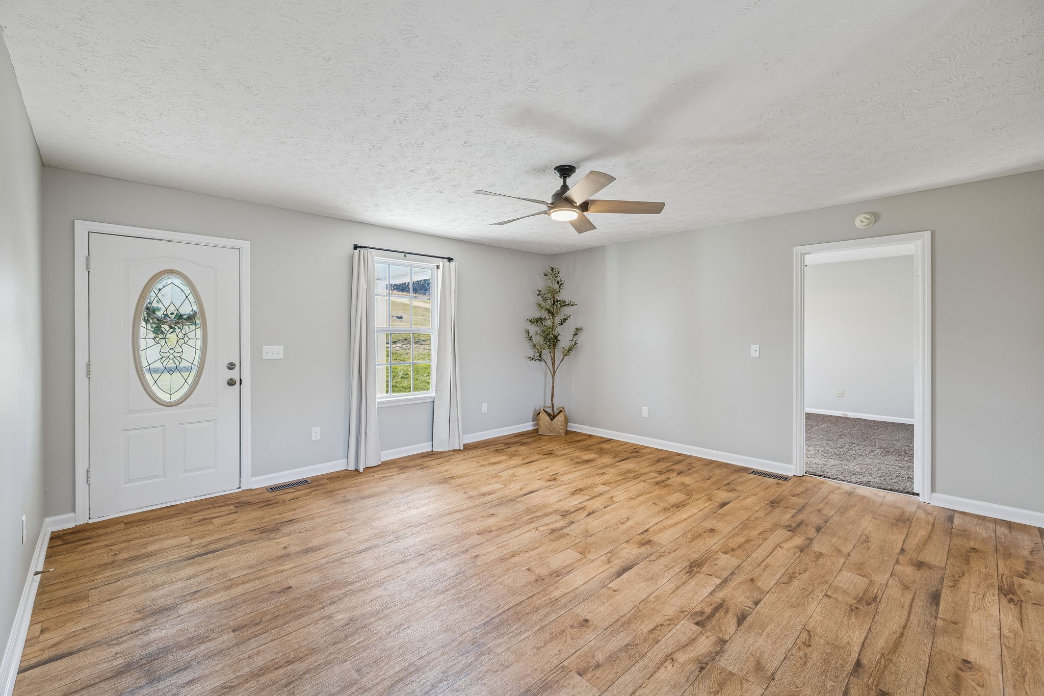 162 Pigeon Roost Road Brush Creek, TN 38547 - Photo 10 of 50 a view of an empty room with window and wooden floor