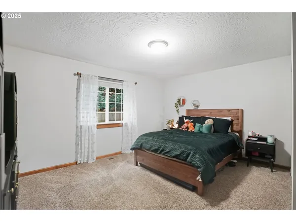 a bedroom with a bed and window