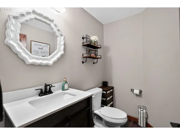 a bathroom with a toilet a sink and mirror