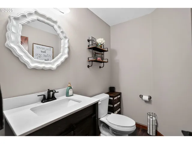 a bathroom with a toilet a sink and mirror