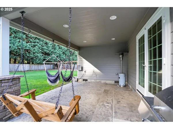 a view of an chairs and table in the back yard