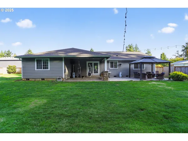 a front view of a house with a yard table and chairs