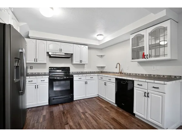 a kitchen with a refrigerator stove and sink