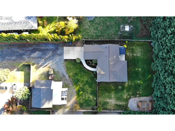 an aerial view of a house with a yard basket ball court and outdoor seating