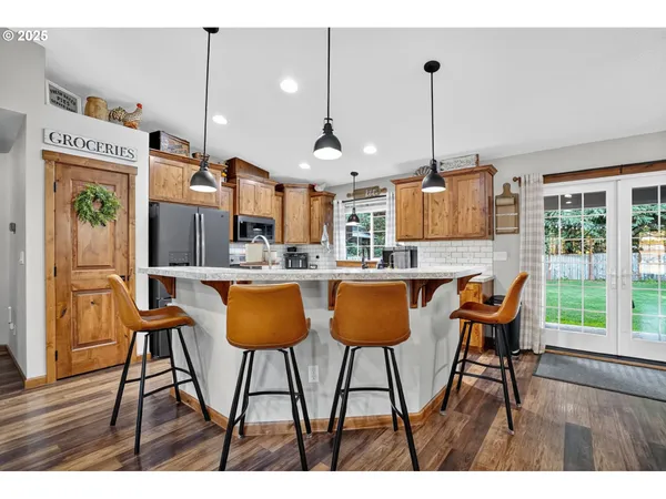 a kitchen with stainless steel appliances kitchen island granite countertop wooden cabinets and a granite counter tops