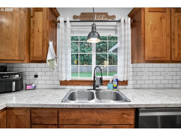 a kitchen with kitchen island a sink a counter appliances and cabinets