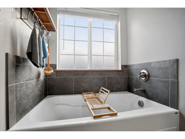 a bathroom with a window and a shower