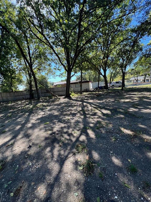 9724 Michael Lane Dallas, TX 75228 - Photo 6 of 7 a view of road with trees