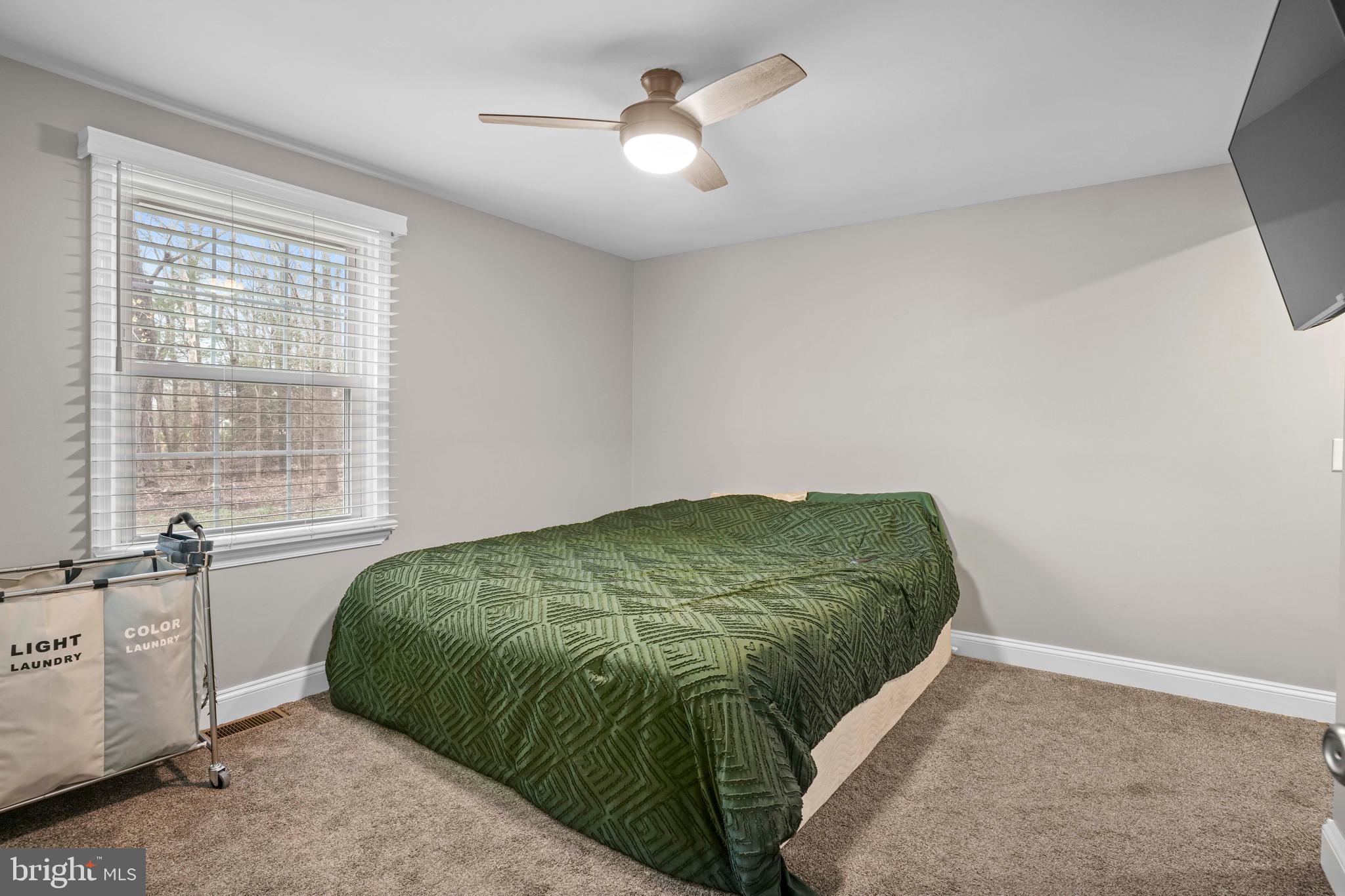 15928 Brandywine Road Brandywine, MD 20613 - Photo 13 of 40 a bedroom with a bed and a chandelier