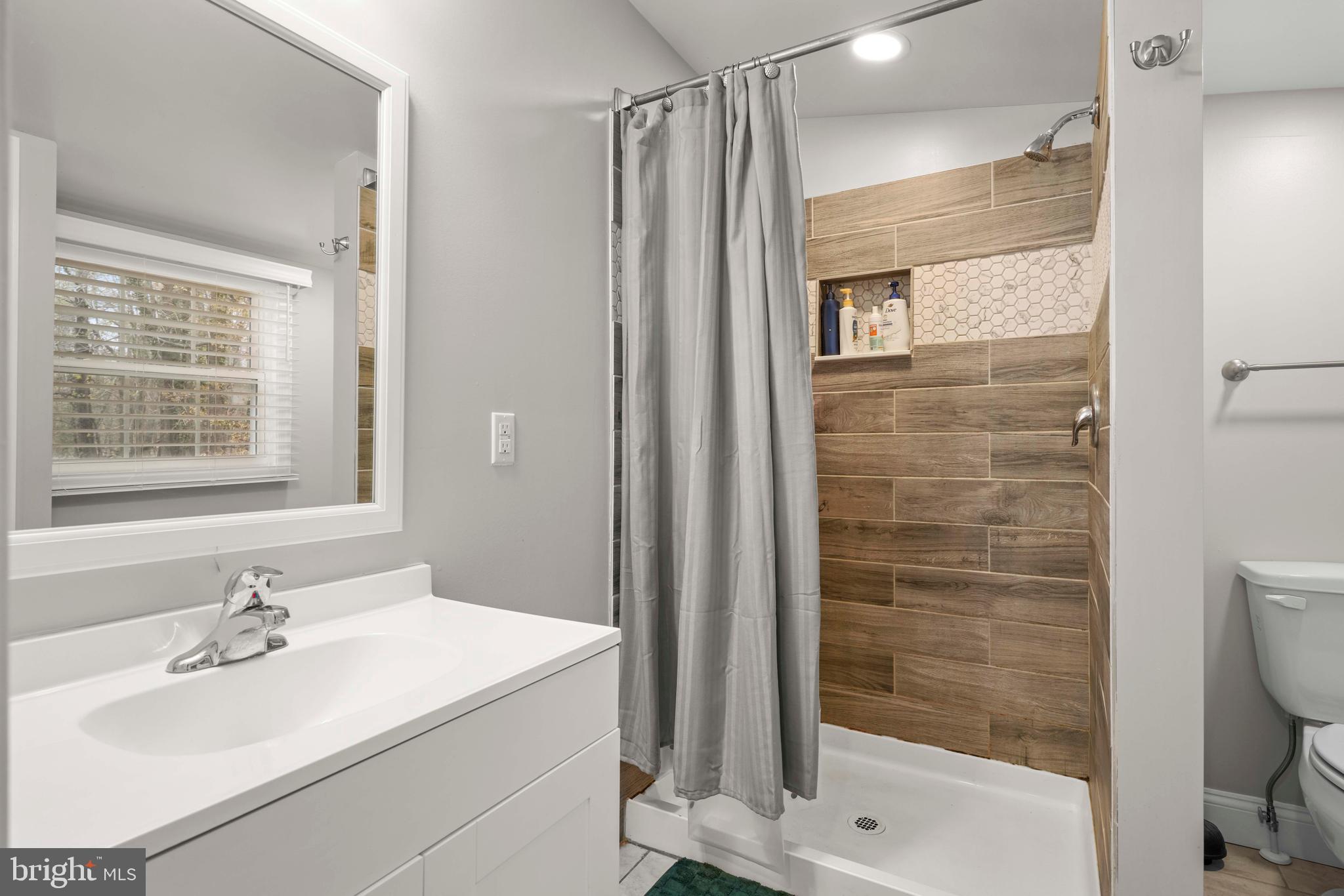 15928 Brandywine Road Brandywine, MD 20613 - Photo 24 of 40 a bathroom with a sink toilet and shower