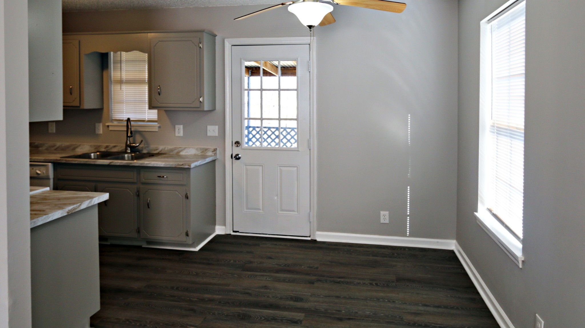 260 Hugh Hunter Road Oak Grove, KY 42262 - Photo 11 of 30 an empty room with wooden floor a sink and windows