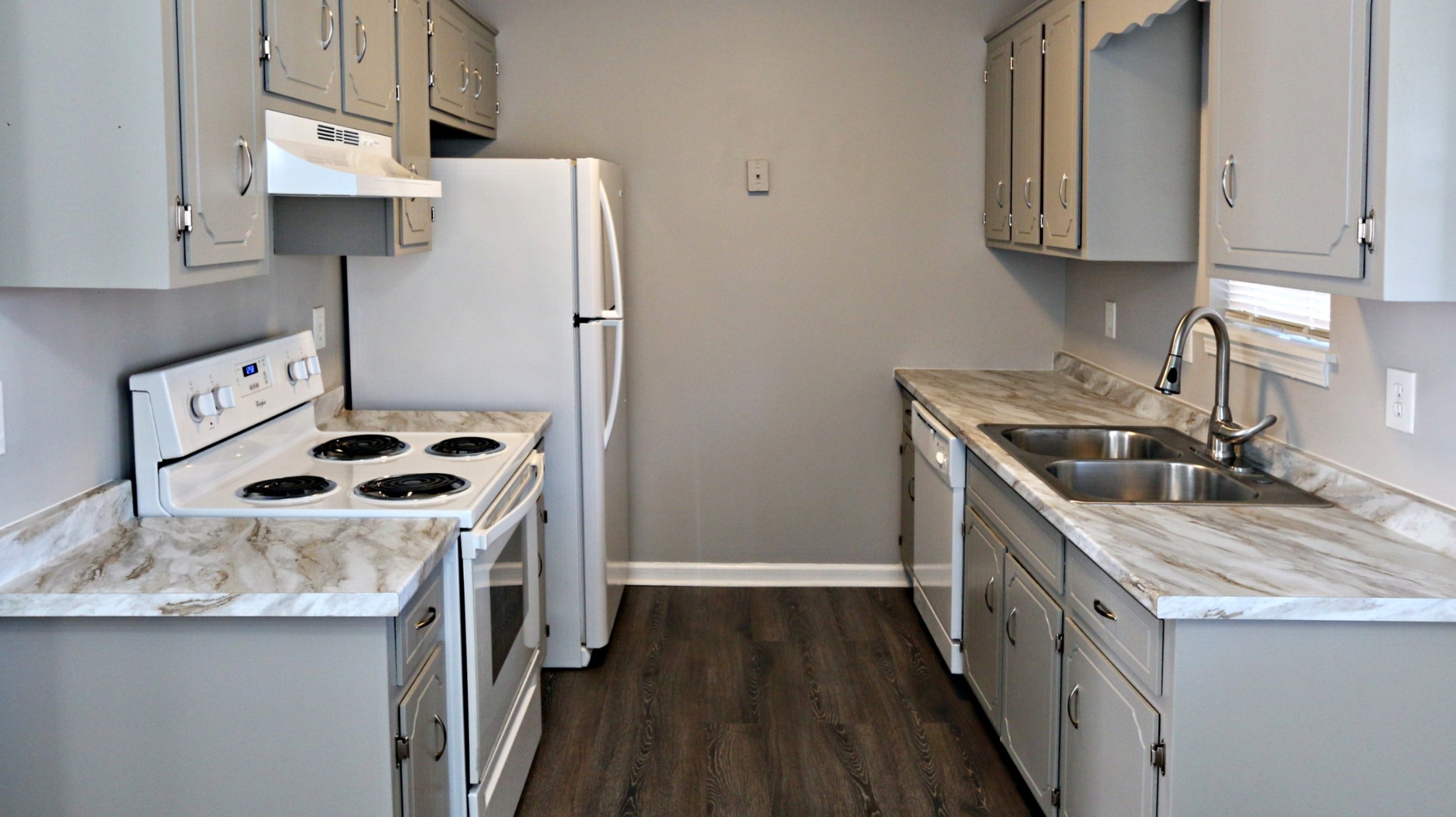 260 Hugh Hunter Road Oak Grove, KY 42262 - Photo 12 of 30 a kitchen with stainless steel appliances a stove a sink a refrigerator and wooden cabinets