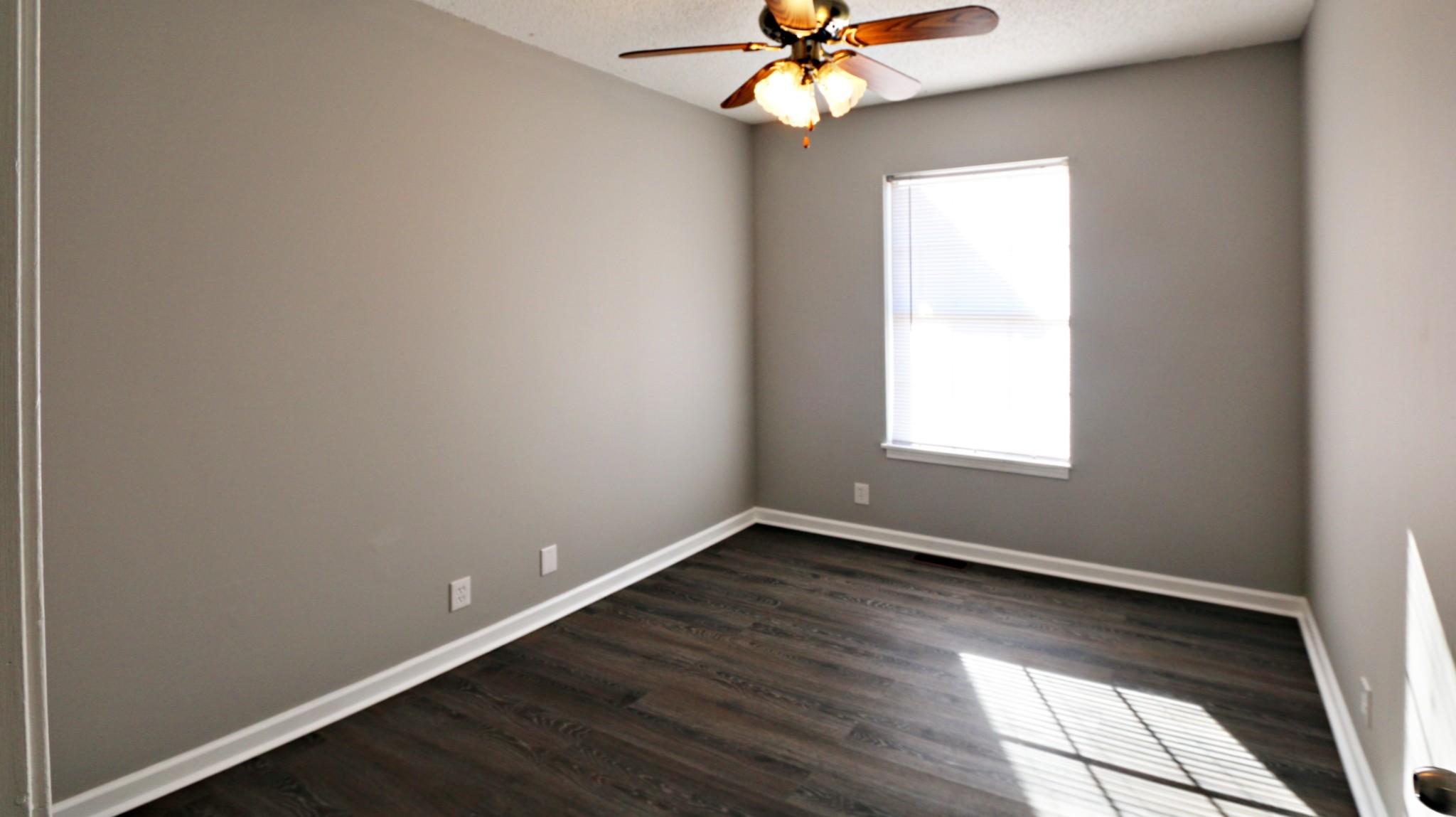 260 Hugh Hunter Road Oak Grove, KY 42262 - Photo 23 of 30 an empty room with wooden floor fan and windows