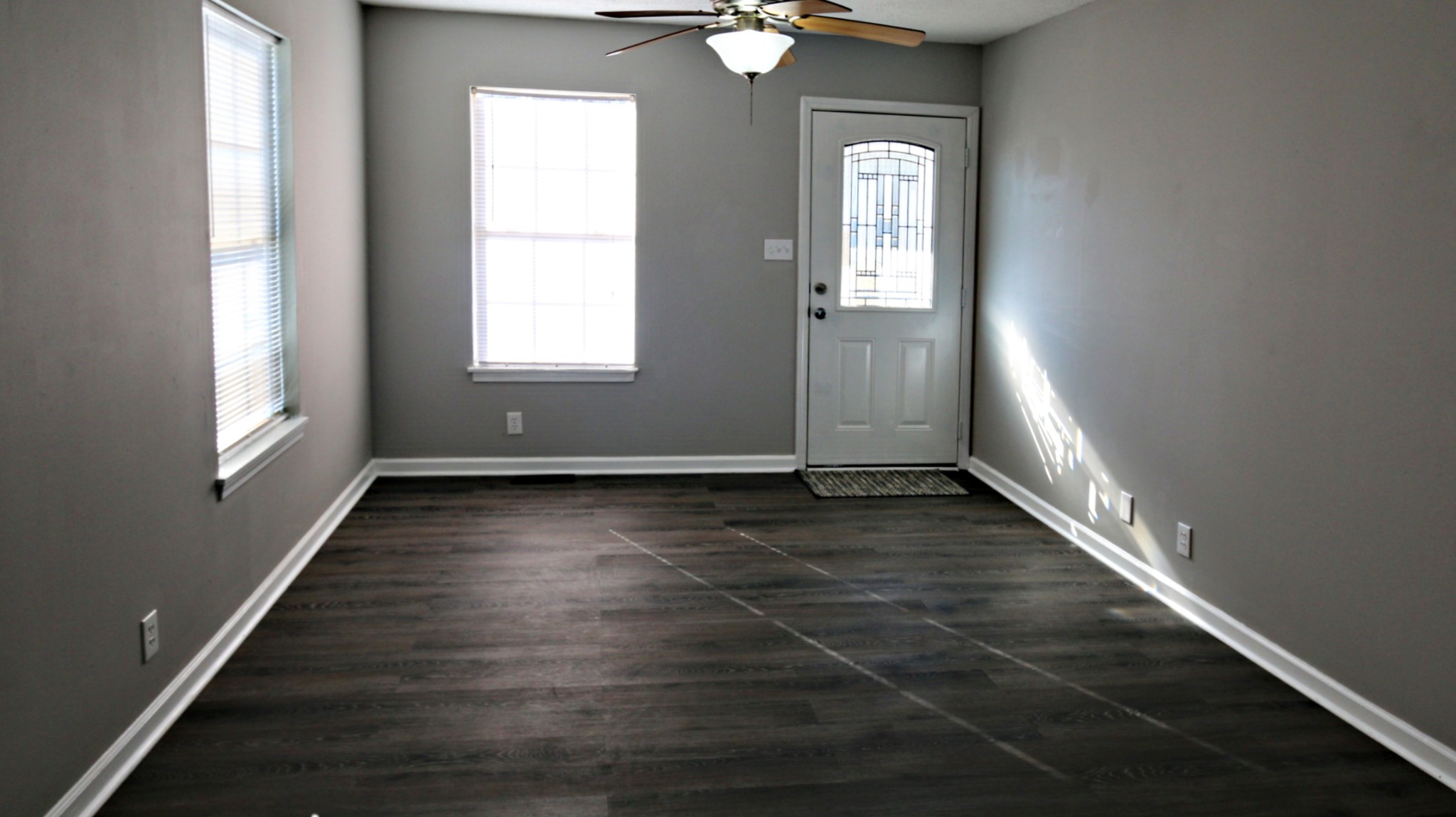 260 Hugh Hunter Road Oak Grove, KY 42262 - Photo 8 of 30 an empty room with wooden floor and windows