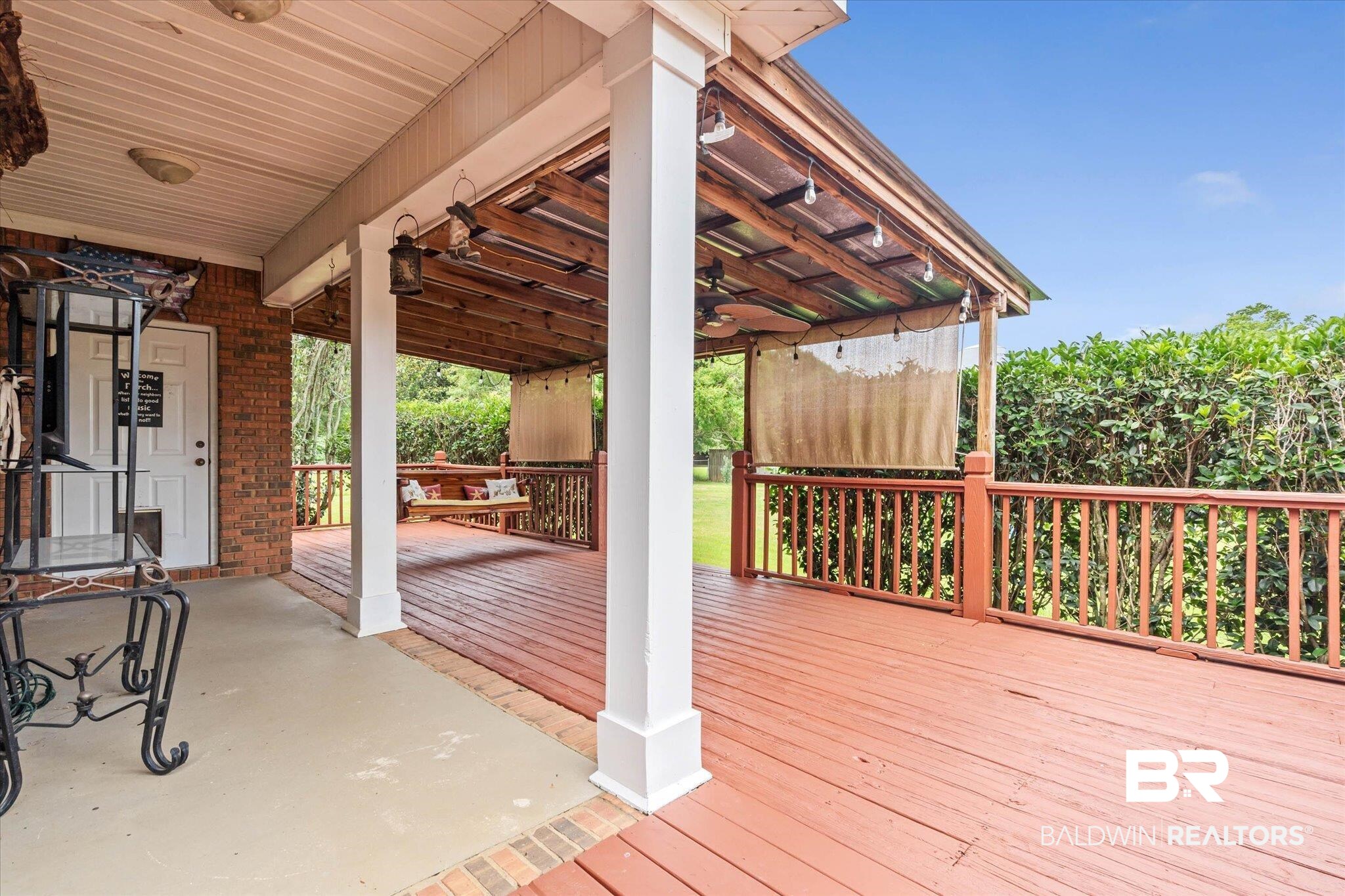 3170 Scott Dairy Loop Road West Mobile, AL 36695 - Photo 18 of 24 Expansive rear deck featuring a red-stained wood surface and a wood railing