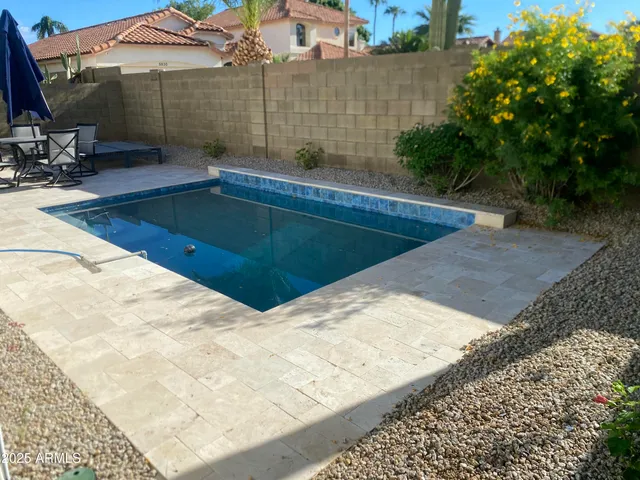 a view of a swimming pool with a patio