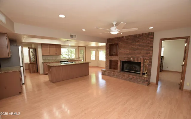 a large kitchen with a fireplace in it