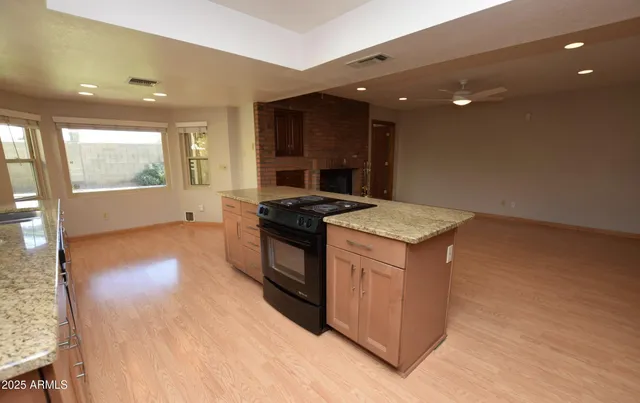 a kitchen that has a sink and a stove in it