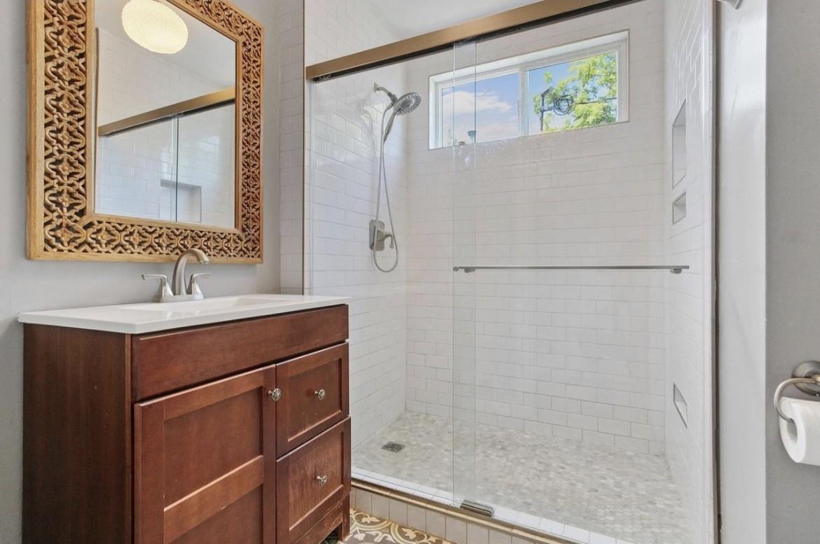 500 Main Street Roseville, CA 95678 - Photo 16 of 23 a bathroom with a shower sink and mirror