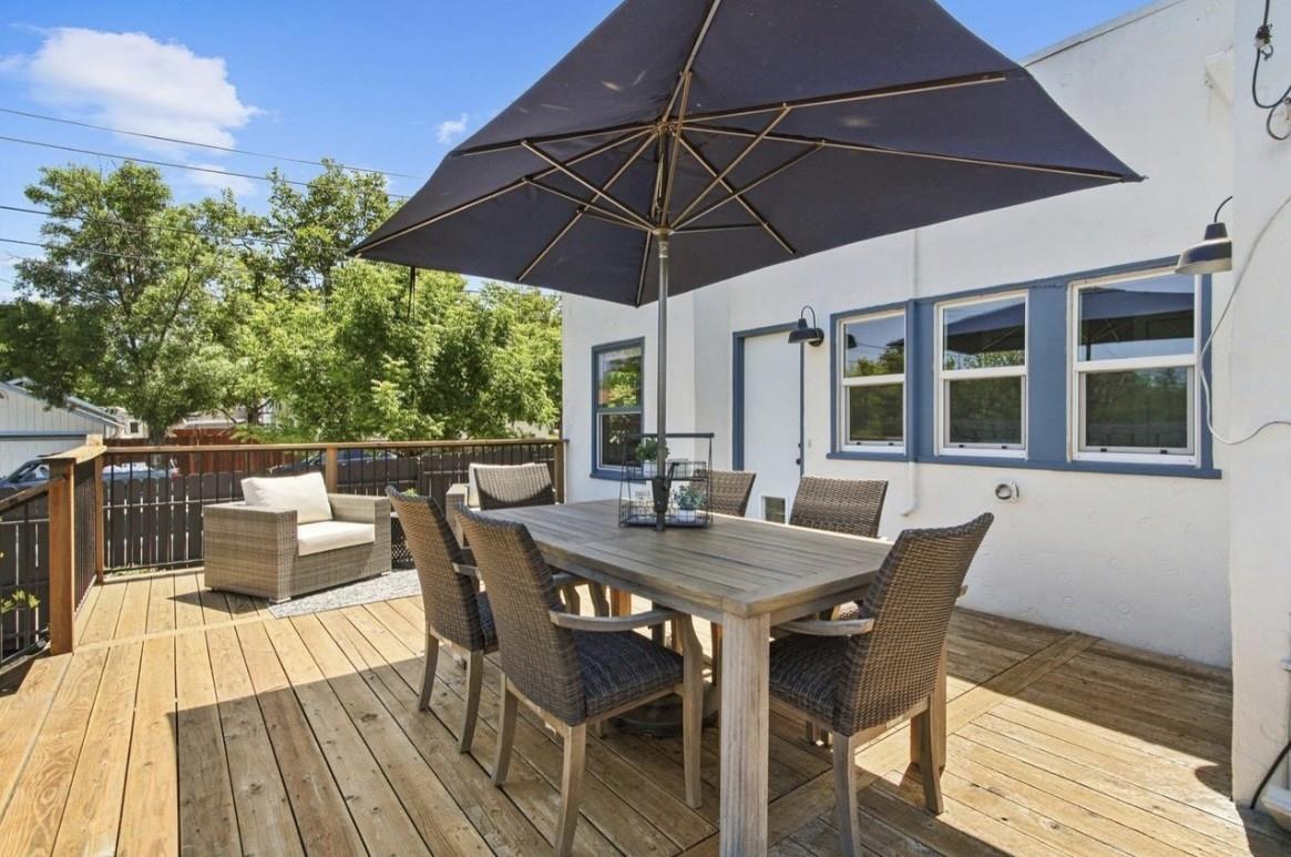 500 Main Street Roseville, CA 95678 - Photo 18 of 23 a view of a roof deck with table and chairs under an umbrella