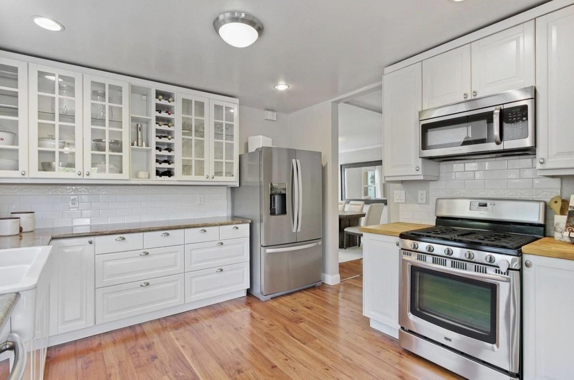 500 Main Street Roseville, CA 95678 - Photo 7 of 23 a kitchen with cabinets stainless steel appliances and wooden floor