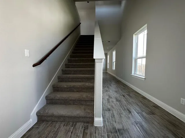 a view of entryway and hall with wooden floor
