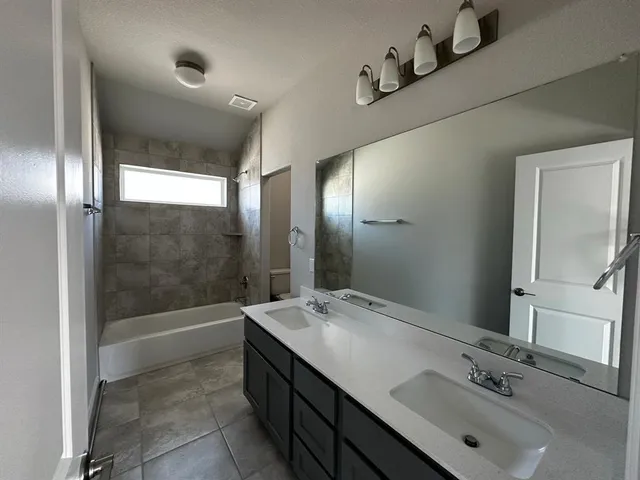 an empty room with closet area and bathroom