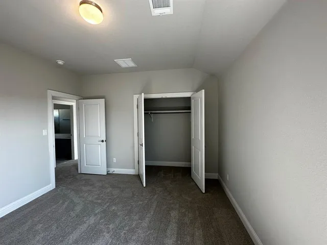 an empty room with a empty space and windows